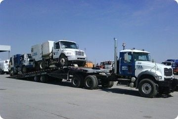 Heavy Equipment Transport in the Winter with Tilt and Load Trucks and Float Trailers Heavy Equipment Transport in the Winter with Tilt and Load Trucks and Float Trailers